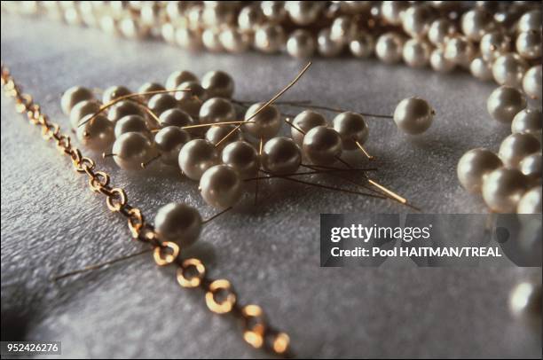 Stringing the celbrated Chanel pearl necklace, Josette Gripoix jeweler.