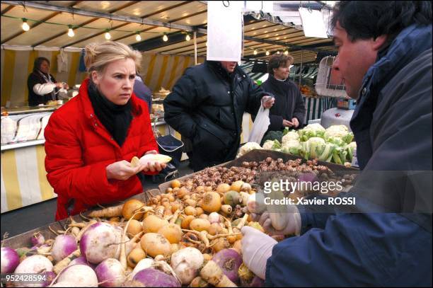 Buying produce from her friend Joel Thiebault on the market of the XVIth arrondissement.
