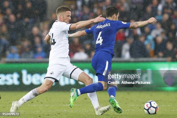 Andy King of Swansea City challenges Cesc Fabregas of Chelsea during the Premier League match between Swansea City and Chelsea at the Liberty Stadium...