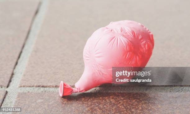 a pink balloon deflated - balloon burst stock pictures, royalty-free photos & images