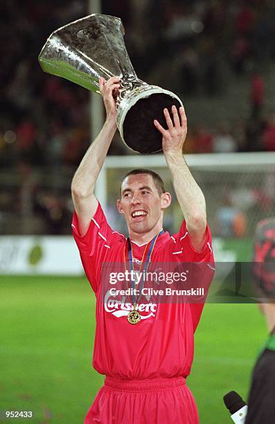 Stephen Wright of Liverpool lifts the trophy after victory in the UEFA Cup Final against Deportivo Alaves at the Westfalenstadion in Dortmund,...