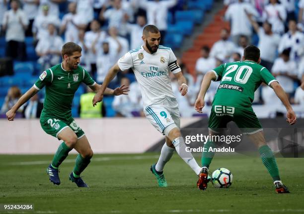 Karim Benzema of Real Madrid in action against Darko Brasanac and Joseba Zaldua of Leganes during La Liga soccer match between Real Madrid and...