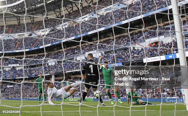 Gareth Bale of Real Madrid scores the opening goal past Ivan Cuellar of Leganes during the La Liga match between Real Madrid and Leganes at Estadio...