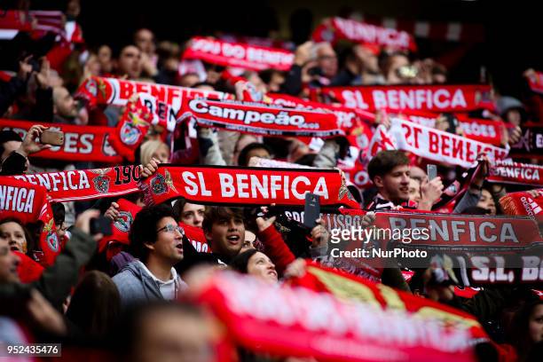 Benfica supporters wave flags during the Portuguese League football match between SL Benfica and Tondela at Luz Stadium in Lisbon on April 28, 2018.