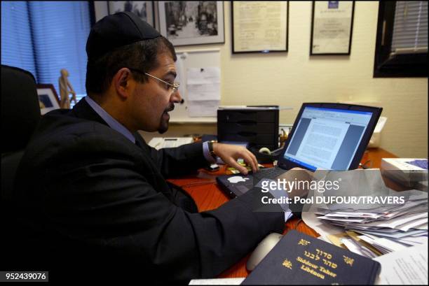 Rabbi Gabriel Farhi in his office writing his prayer.