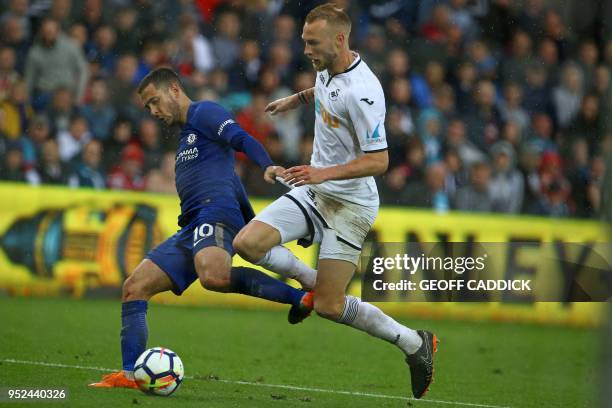 Chelsea's Belgian midfielder Eden Hazard vies with Swansea City's Dutch defender Mike van der Hoorn during the English Premier League football match...