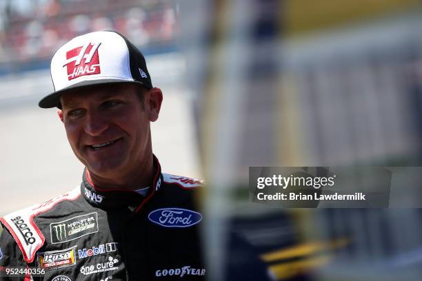 Clint Bowyer, driver of the Haas Automation Demo Day Ford, stands on the grid during qualifying for the Monster Energy NASCAR Cup Series GEICO 500 at...