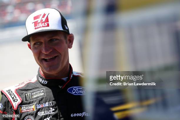 Clint Bowyer, driver of the Haas Automation Demo Day Ford, stands on the grid during qualifying for the Monster Energy NASCAR Cup Series GEICO 500 at...