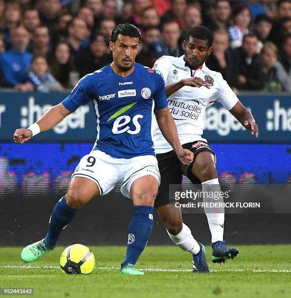 Nice's Brasil defender Santos Marlon vies with Strasbourg's Algerian forward Idriss Saadi during the French L1 football match between Strasbourg and...