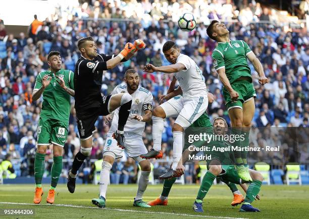 Casemiro of Real Madrid competes for the ball with Ivan Cuellar of Leganes during the La Liga match between Real Madrid and Leganes at Estadio...