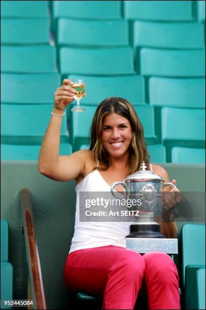 Jennifer Capriati post final photo shot with French open trophy in stands at Roland Garros.