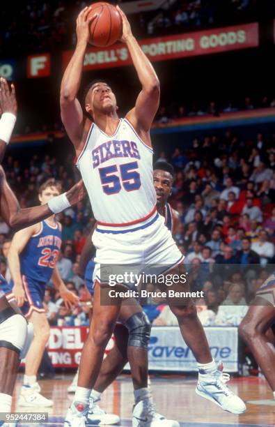 Jayson Williams of the Philadelphia 76ers grabs the rebound during an NBA game against the New York Knicks on March 13, 1991 at the Spectrum in...