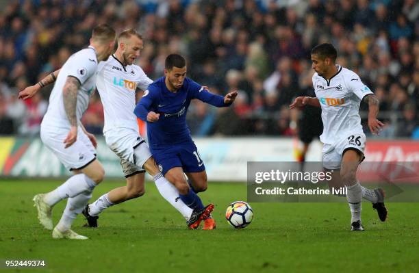 Eden Hazard of Chelsea is surrounded as Mike van der Hoorn of Swansea City tackles him during the Premier League match between Swansea City and...