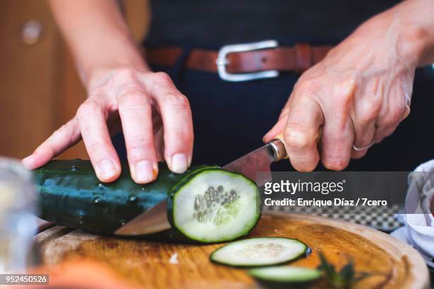 salad preparation: slicing cucumber 2 - cucumber imagens e fotografias de stock