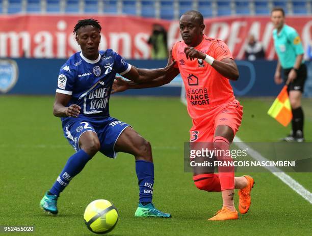 Troyes' Malian defender Charles Traore vies with Caen's forward Christian Kouakou during the French L1 football match between Troyes and Caen on...