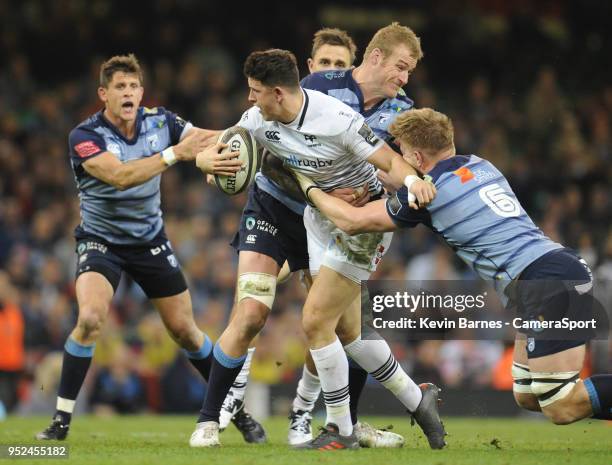 Ospreys' Owen Watkin is tackled by Cardiff Blues' Damian Welch and Macauley Cook during the Guinness PRO14 Round 21 Judgement Day VI match between...