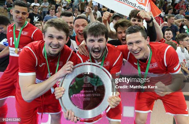 The players of Hohenstein Ernstthal celebrate with the trophy after winning the German Futsal Championship final match between VfL...