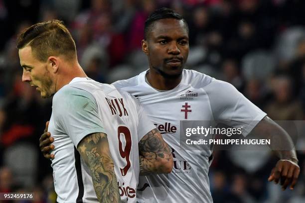 Metz's French forward Nolan Roux is congratulated by teammate Cameroonian midfielder Georges Mandjeck after scoring a goal during the French L1...