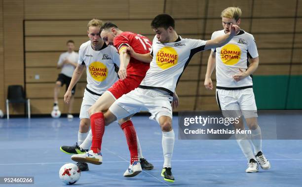 Christopher Wittig of Hohenstein Ernstthal battles for the ball with Jilo Hirosawa of Koeln during the German Futsal Championship final match between...