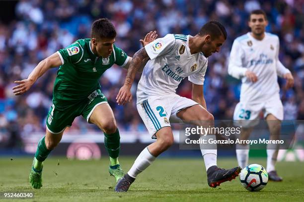 Daniel Ceballos of Real Madrid CF competes for the ball with Unai Bustinza of Deportivo Leganes during the La Liga match between Real Madrid CF and...