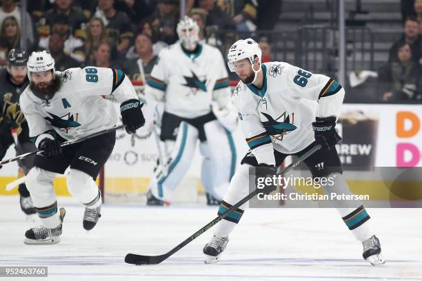 Melker Karlsson of the San Jose Sharks skates with the puck ahead of Brent Burns in Game One of the Western Conference Second Round against the Vegas...
