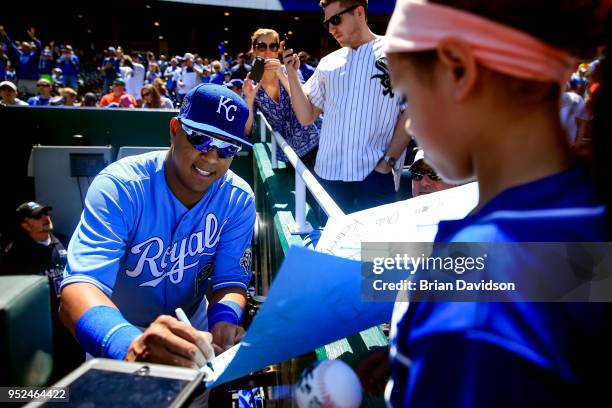 Salvador Perez of the Kansas City Royals signs an autograph before game one of a doubleheader against the Chicago White Sox at Kauffman Stadium on...