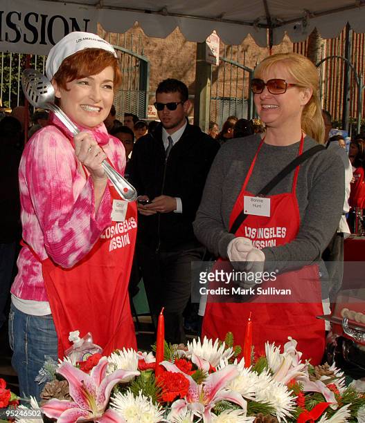 Actresses Carolyn Hennesy and Bonnie Hunt volunteer at the Los Angeles Mission Christmas Eve meal on December 24, 2009 in Los Angeles, California.