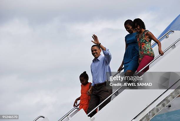 President Barack Obama, First Lady Michelle Obama and their daughters Malia and Sasha disembark from Air Force One upon their arrival at the Hickam...