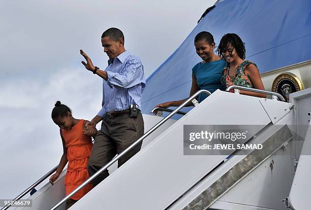 President Barack Obama, First Lady Michelle Obama and their daughters Malia and Sasha disembark from Air Force One upon their arrival at the Hickam...