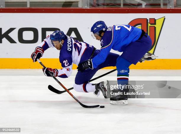 Ben Oconnor of Great Britain competes for the puck with Ivan Deluca of Italy during the 2018 IIHF Ice Hockey World Championship Division I Group A...