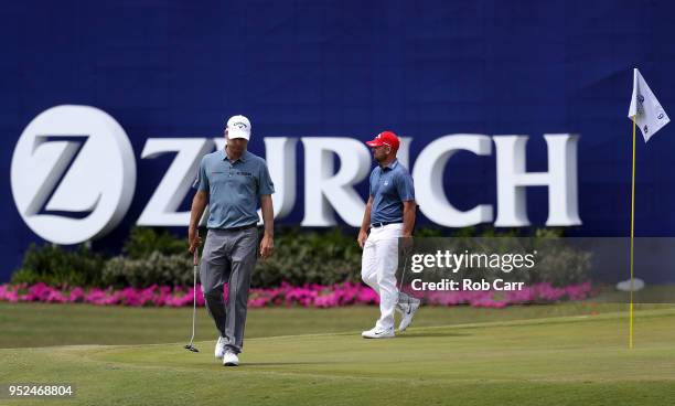 Kevin Kisner and Scott Brown walk onto the ninth green during the third round of the Zurich Classic at TPC Louisiana on April 28, 2018 in Avondale,...