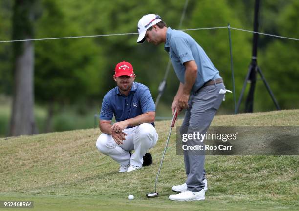 Kevin Kisner and Scott Brown line up a putt on the eighth hole during the third round of the Zurich Classic at TPC Louisiana on April 28, 2018 in...