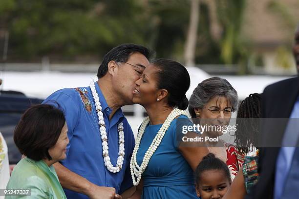 Honolulu Mayor Mufi Hannemann greets First Lady Michelle Obama with a kiss and a lei at Hickam Air Force Base on December 24, 2009 in Honolulu,...