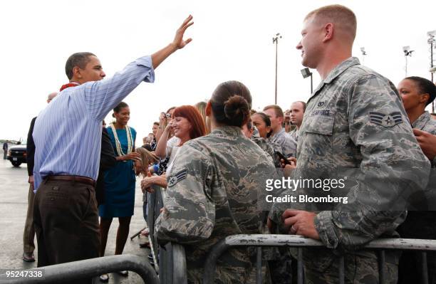 President Barack Obama and First Lady Micelle Obama greets supporters at Hickam Air Force Base in Honolulu, Hawaii, U.S., on Thursday, Dec. 24, 2009....