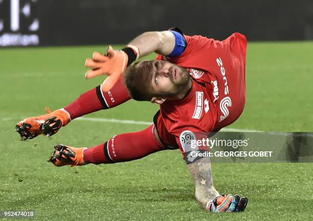 Dijon's French goalkeeper Baptiste Reynet jumps to catch the ball during the French L1 football match between FC Girondins de Bordeaux and Dijon FCO...