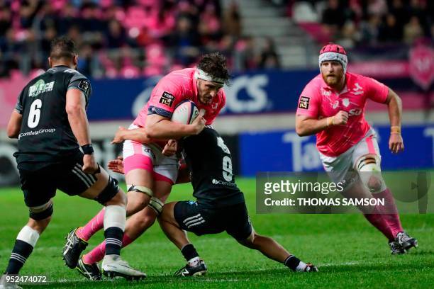 Stade Francais' French lock Paul Gabrillagues is tackled by Brive's French scrumhalf Samuel Marques during the French Top 14 rugby union match...