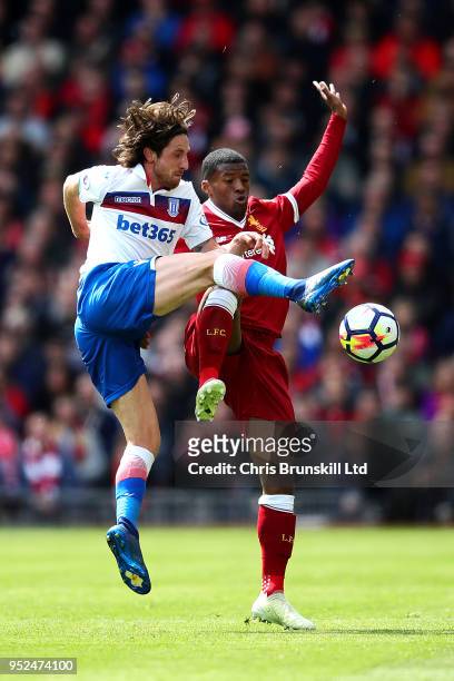 Georginio Wijnaldum of Liverpool in action with Joe Allen of Stoke City during the Premier League match between Liverpool and Stoke City at Anfield...