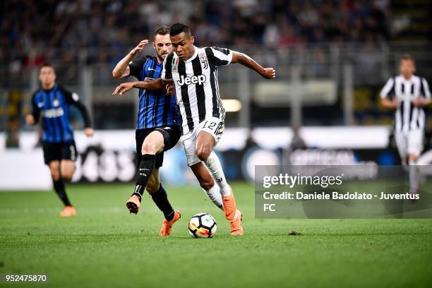 Alex Sandro of Juventus competes for the ball with Marcelo Brozovic of FC Internazionale during the serie A match between FC Internazionale and...