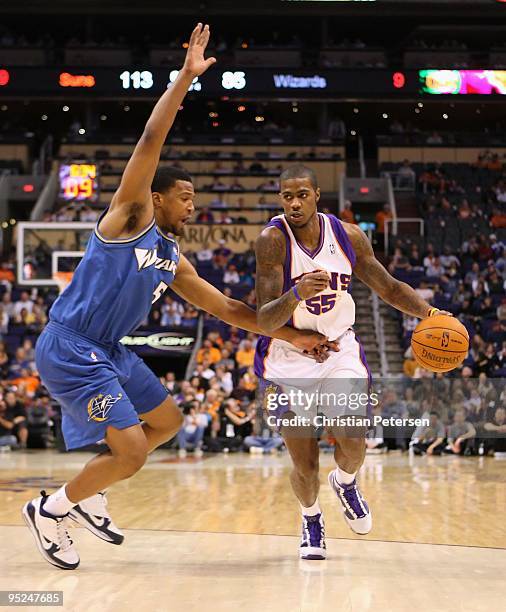 Earl Clark of the Phoenix Suns handles the ball under pressure from Dominic McGuire of the Washington Wizards during the NBA game at US Airways...