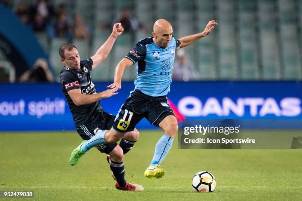 Sydney FC midfielder Adrian Mierzejewski and Melbourne Victory defender Leigh Brougham come together at the A-League Semi-Final Soccer Match between...