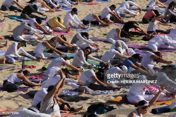People practice yoga, during a meeting organized by YSYoga System at the Samalayuca desert, Juarez municipality, Chihuahua state, Mexico, on April...