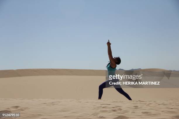 Woman attends a yoga class, during a meeting organized by YSYoga System at the Samalayuca desert, Juarez municipality, Chihuahua state, Mexico, on...
