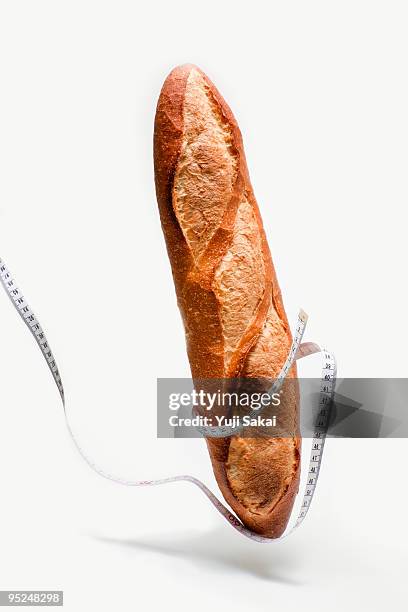 tape measure  around french  bread in the air - baguette stock pictures, royalty-free photos & images