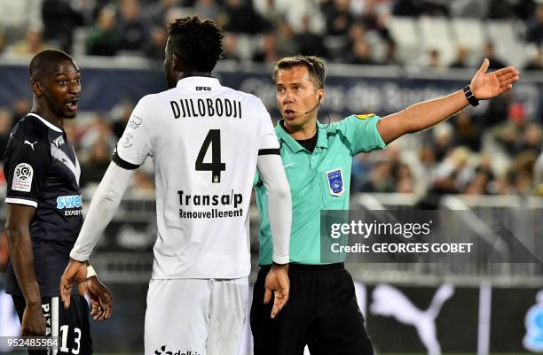 French referee Johan Hamel asks arguing players, Bordeaux' Senegalese midfielder Younousse Sankhare and Dijon's Senegalese defender Papy Djilobodji,...