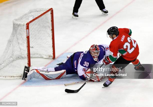 Janos Hari of Hungary misses a penalty shot next to goalie Ben Bowns of Great Britain during the 2018 IIHF Ice Hockey World Championship Division I...