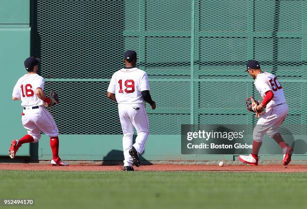 Boston Red Sox center fielder Jackie Bradley Jr., left fielder Andrew Benintendi , Bradley Jr. And right fielder Mookie Betts chase after the ball...