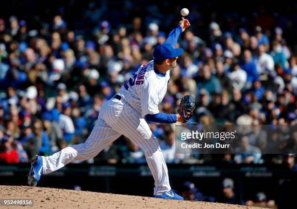 Brian Duensing of the Chicago Cubs pitches against the Milwaukee Brewers during the ninth inning at Wrigley Field on April 28, 2018 in Chicago,...