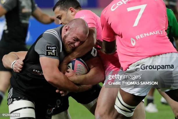 Brive's French prop Vivien Devisme is tackled during the French Top 14 rugby union match between Paris Stade Francais and Brive CAB on April 28, 2018...