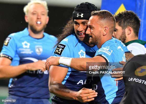 Montpellier's New Zealand flyhalf Aaron Cruden is congratulated by teammate Montpellier's Austalian winger Joe Tomane after scoring a try during the...