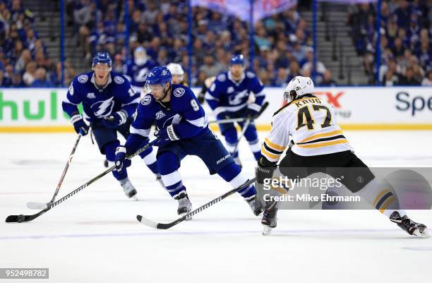 Tyler Johnson of the Tampa Bay Lightning and Torey Krug of the Boston Bruins fight for the puck during Game One of the Eastern Conference Second...